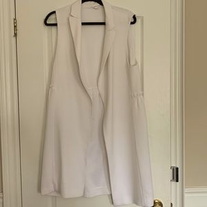 White vest. Ruffle across back